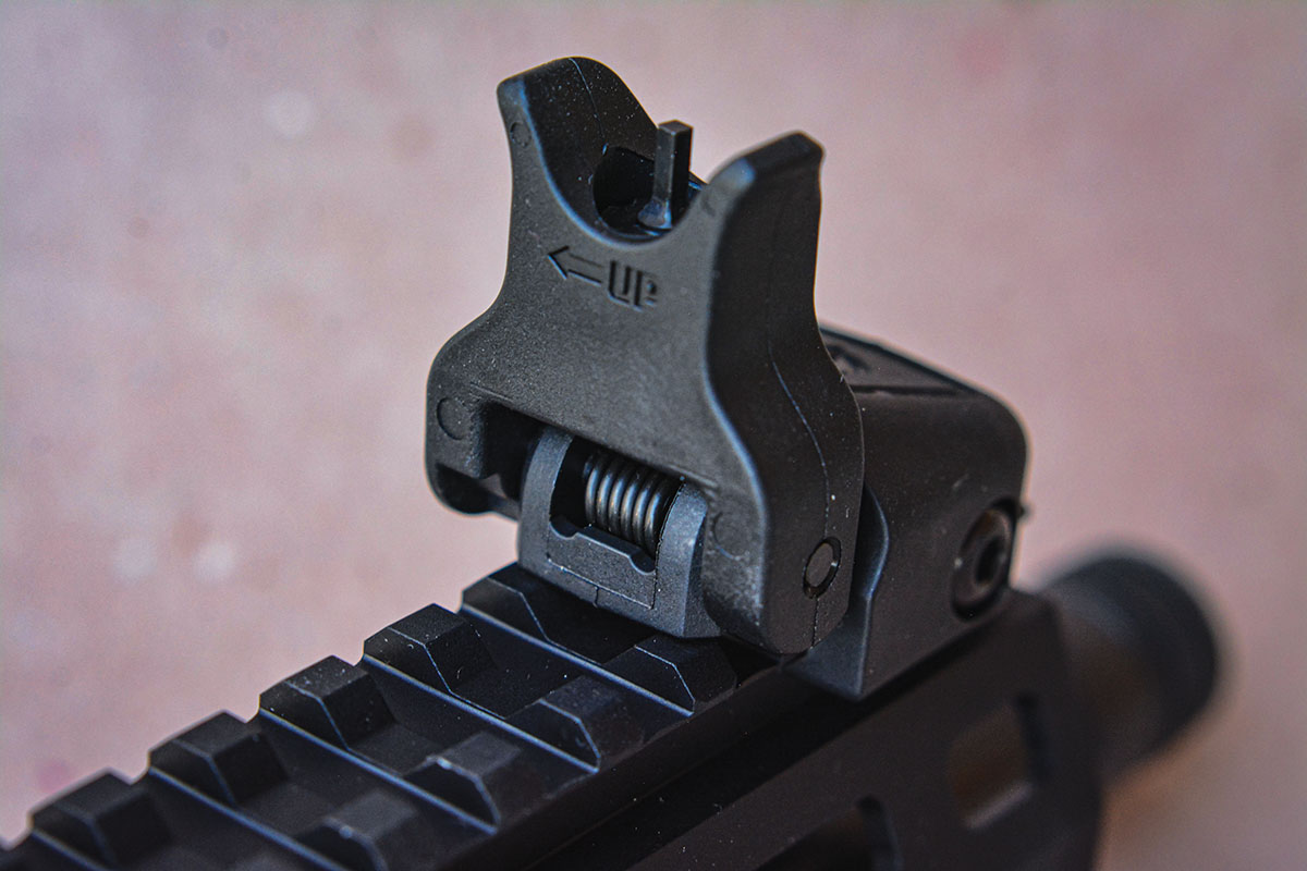 The front sight is adjustable for elevation and can be folded down.